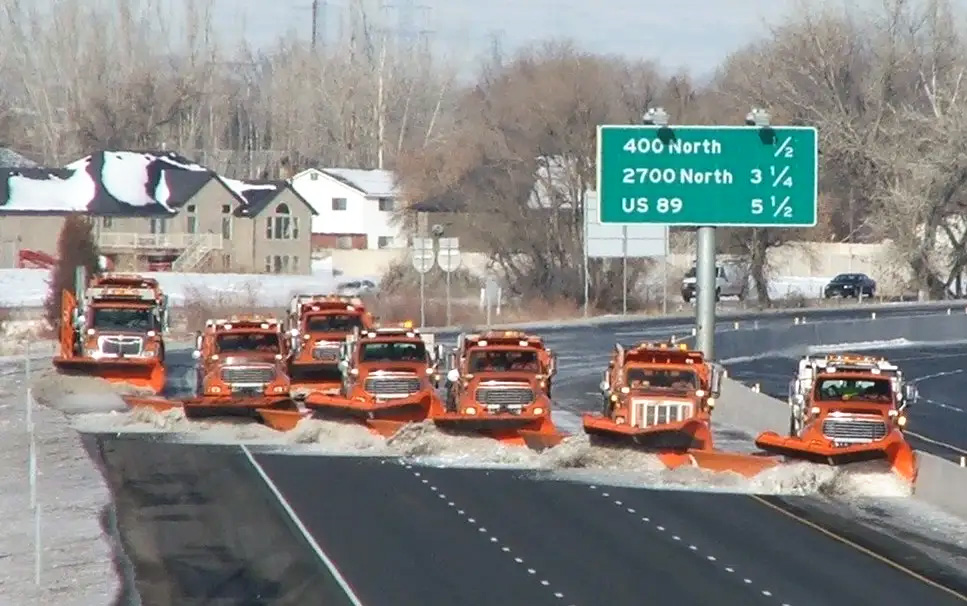 Seven Snowplows on the freeway.
